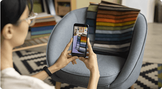 Person using home design app on mobile phone